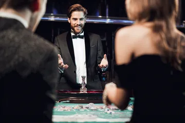A professional dealer in a tuxedo greeting players at the roulette table, symbolizing the authentic live casino feel at WA777PK.